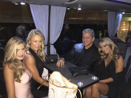 Bruce Buffer poses a picture with his wife and their friends.